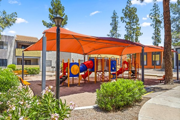 Modern playground with slides and swings at Villatree Apartments, offering family-friendly outdoor spaces