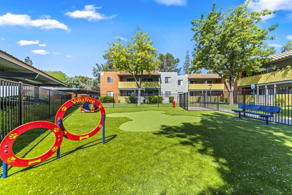 Dog park with agility equipment at Villatree Apartments, offering pet-friendly amenities for luxury living