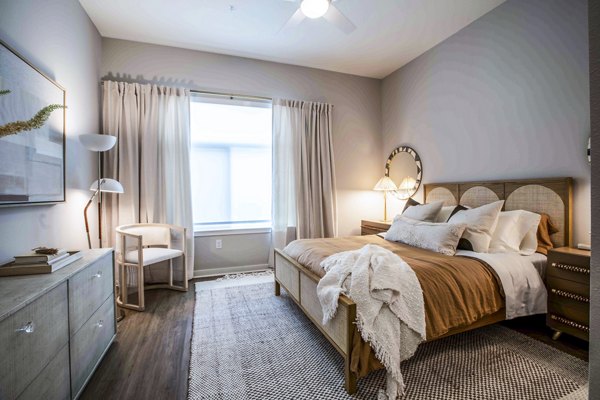 Cozy bedroom with modern furnishings at Lynwind Apartments, perfect for luxury living