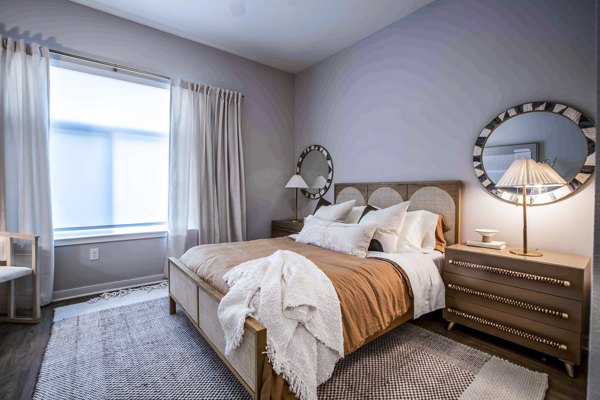 Cozy bedroom with stylish decor at Lynwind Apartments, showcasing luxury living