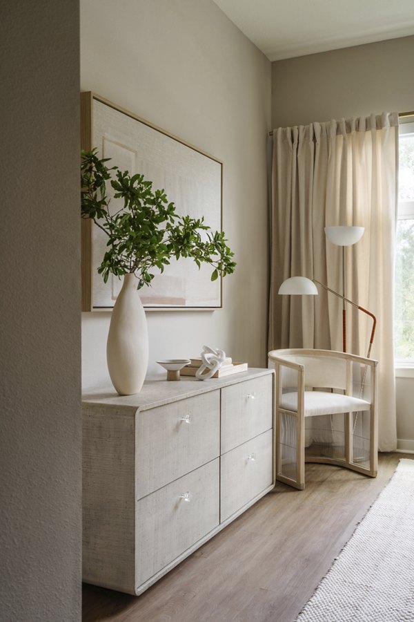Bedroom with modern decor and large windows at Lynwind Apartments, luxury living space providing comfort and style
