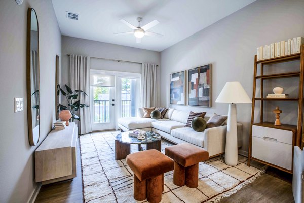 Lynwind Apartments: Cozy living room with modern decor and large windows