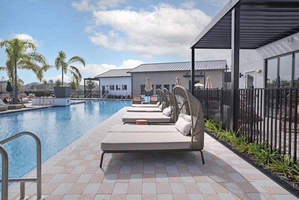 Modern pool with lounge chairs at Lynwind Apartments, offering a luxury living experience