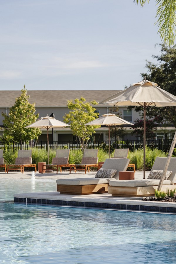 Olympic-sized pool with loungers at Lynwind Apartments, offering luxury living for residents seeking relaxation and recreation