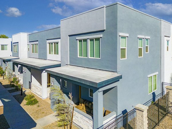 Town Surprise Apartments: Elegant townhome exteriors with manicured landscaping in a serene neighborhood