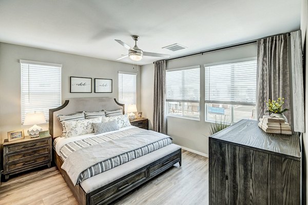 Comfortable bedroom with cozy decor in Town Surprise Townhome Apartments