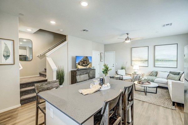 Dining room with elegant furniture and natural lighting at Town Surprise Townhome Apartments
