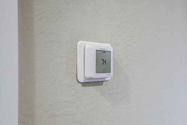 Hallway thermostat for efficient climate control at Town Surprise Apartment Townhomes