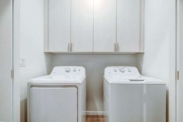 Laundry room with modern appliances at Town Surprise Townhome Apartments