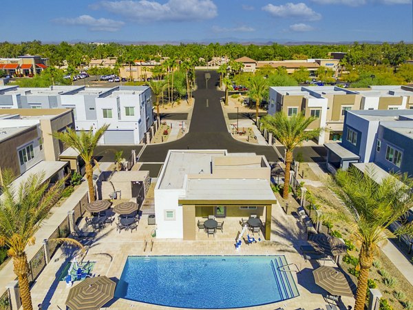 Resort-style pool area with lounge chairs at Town Surprise Apartment Townhomes, a luxurious rental community