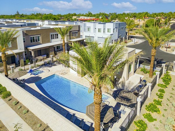 Inviting pool at Town Surprise Apartment Townhomes: Relaxing retreat surrounded by lush landscaping and modern design