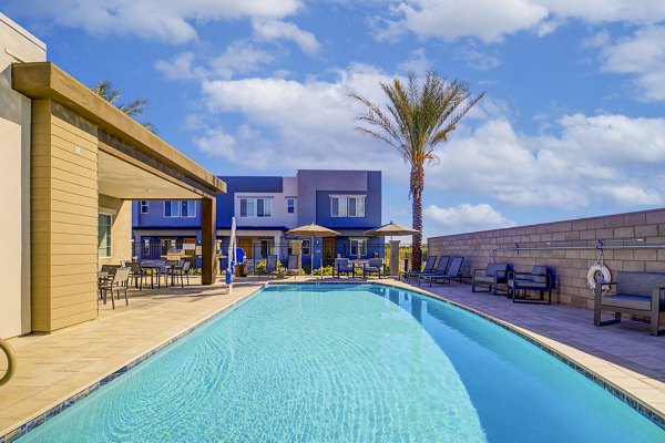 Resort-style pool with spacious lounge area at Town Surprise Apartment Townhomes
