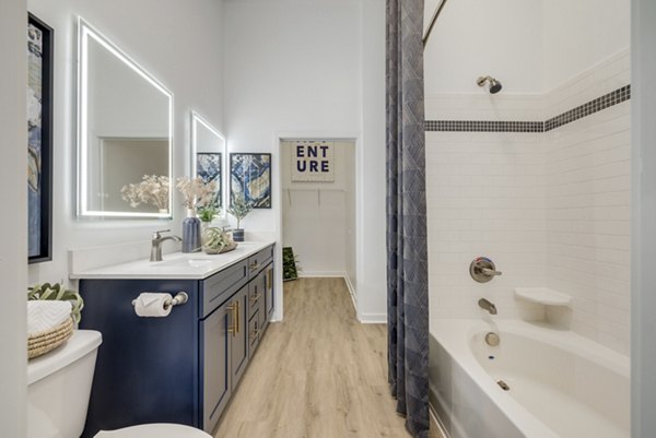 Bathroom featuring elegant fixtures and marble countertops at Midtown 205 Apartments