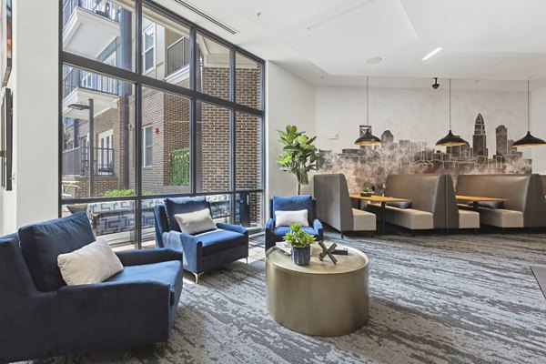 Clubhouse with modern decor and seating at Midtown 205 Apartments