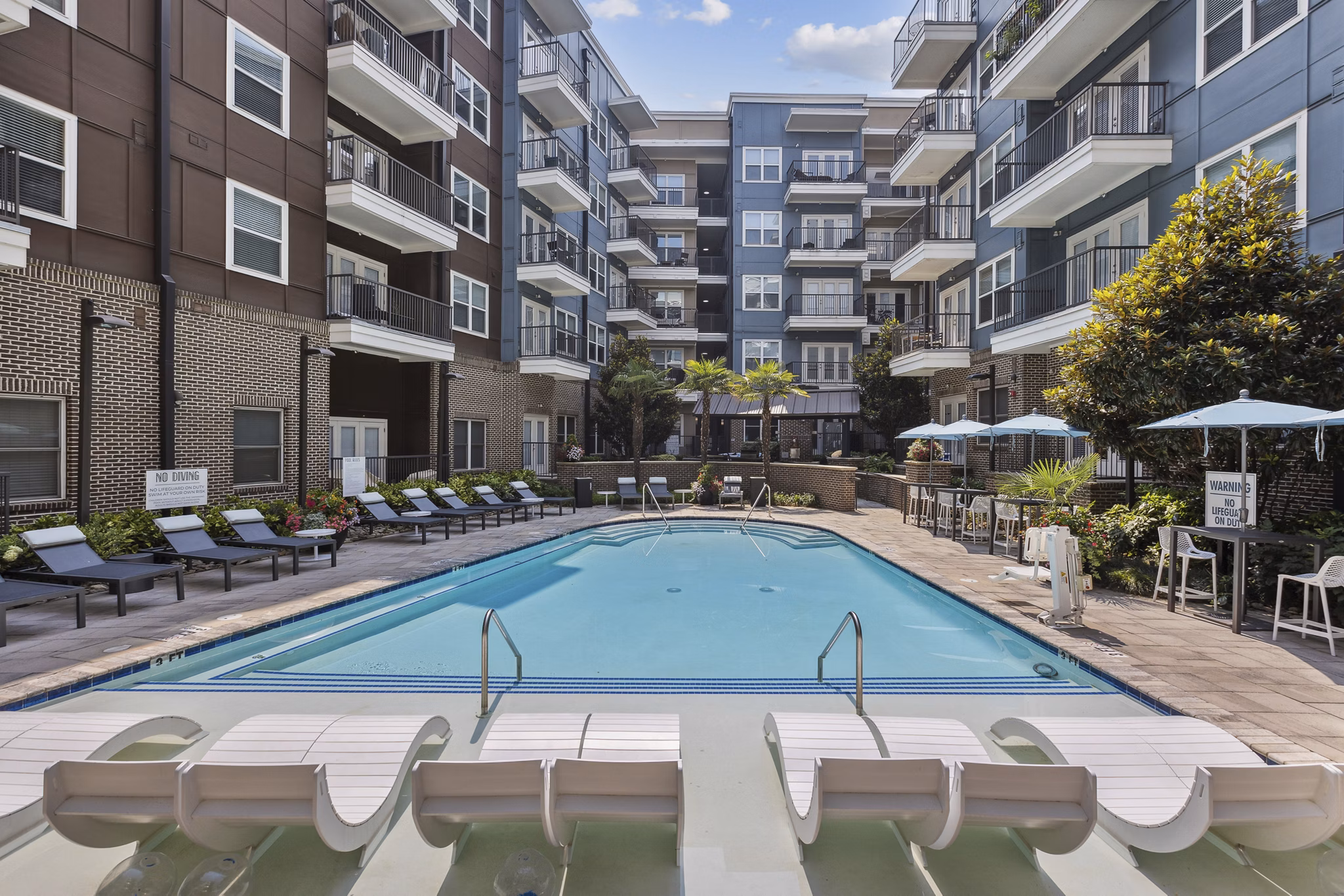 Stunning rooftop pool with sun loungers at Midtown 205 Apartments, perfect for relaxation and leisure