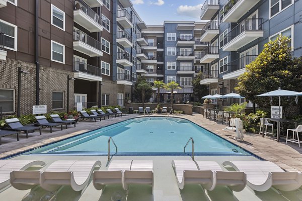 Stunning rooftop pool with sun loungers at Midtown 205 Apartments, perfect for relaxation and leisure