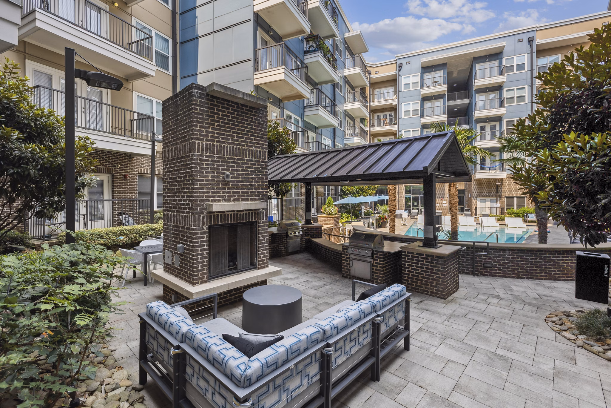 Modern patio with cozy seating and greenery at Midtown 205 Apartments, a luxury living community in the heart of urban Charlotte