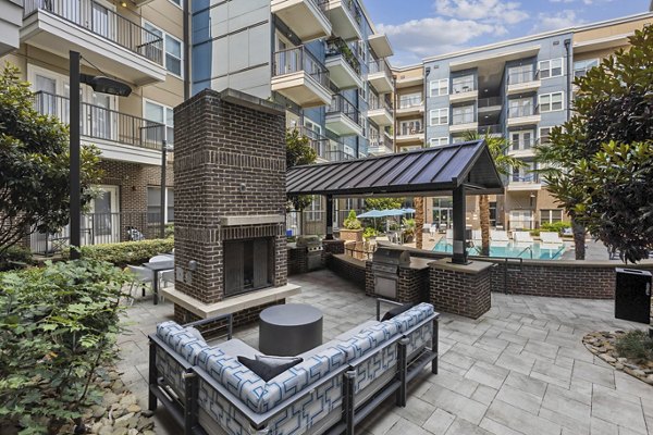 Modern patio with cozy seating and greenery at Midtown 205 Apartments, a luxury living community in the heart of urban Charlotte