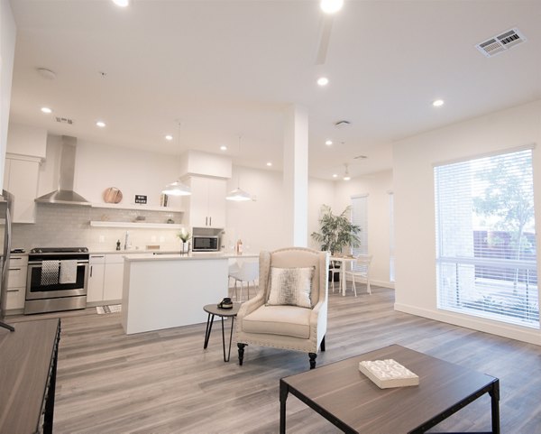 Living room with modern decor and large windows at Parc Haven Apartments