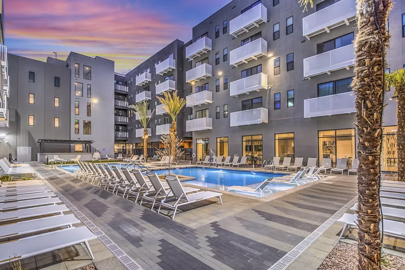 Serene poolside at Parc Haven Apartments featuring luxury sun loungers and lush greenery