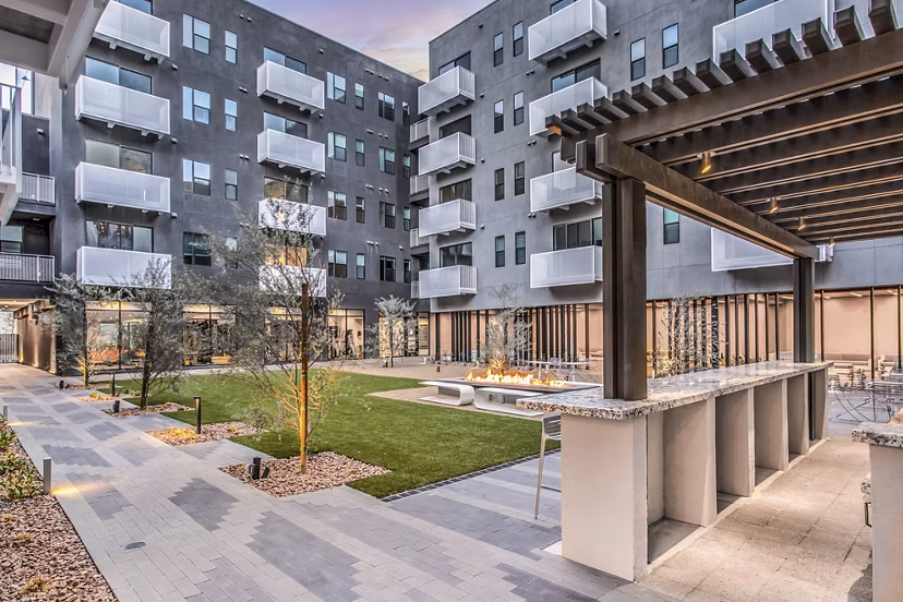 Courtyard with lush greenery and seating areas at Parc Haven Apartments in Las Vegas
