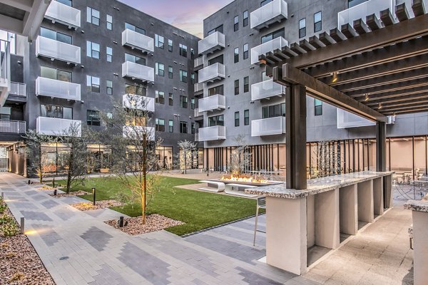Courtyard with lush greenery and seating areas at Parc Haven Apartments in Las Vegas