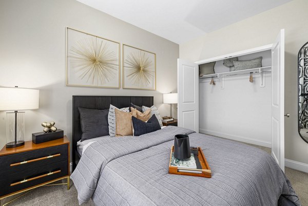 Cozy bedroom with neutral tones and large window at Banyan Silo Ridge Apartments