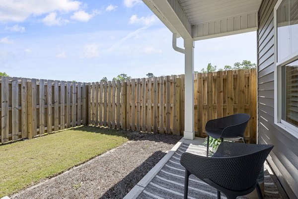 Patio area with modern seating at Banyan Silo Ridge Apartments, perfect for outdoor relaxation and socializing