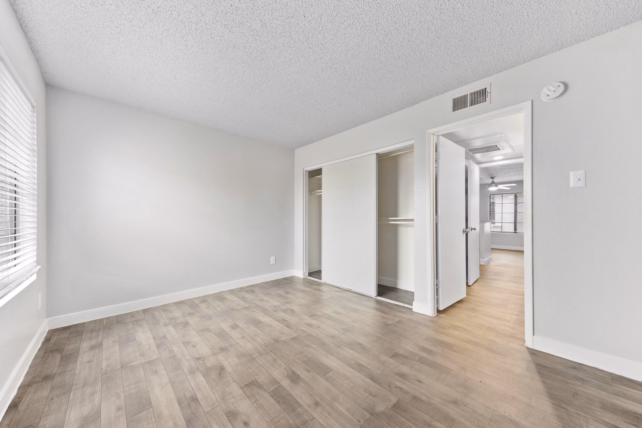 Cozy bedroom with modern decor and large windows at Verve Apartments