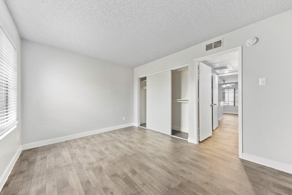 Cozy bedroom with modern decor and large windows at Verve Apartments
