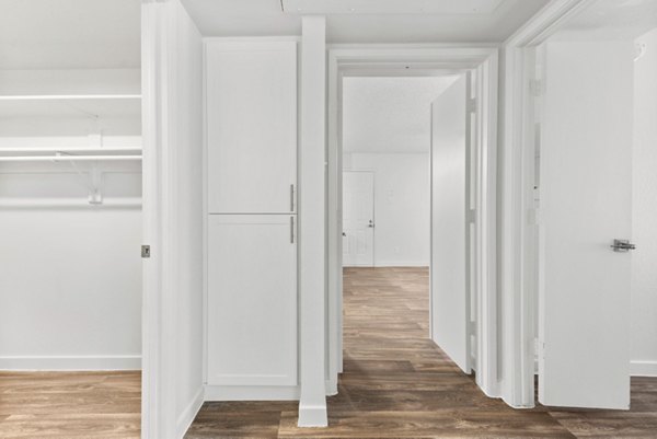 Contemporary kitchen with marble countertops and stainless steel appliances in Verve Apartments