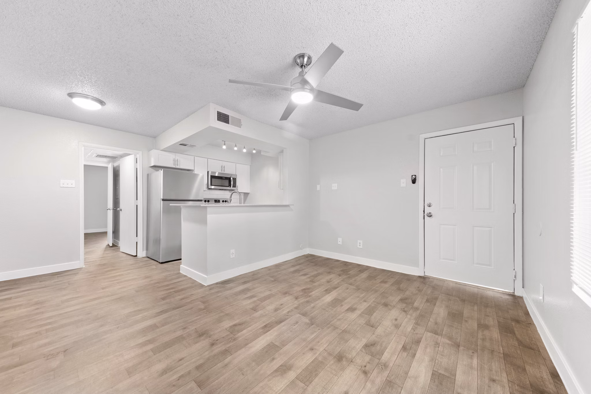 Kitchen with stainless steel appliances and granite countertops in Verve Apartments