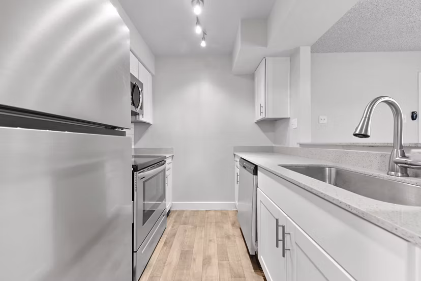 Modern kitchen with sleek countertops and stainless steel appliances in Verve Apartments