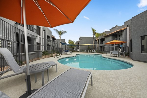 Stylish pool surrounded by lounge chairs at Verve Apartments
