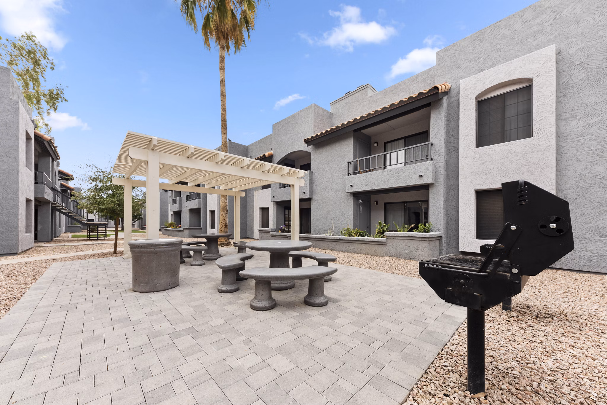 Verve Apartments: Lush courtyard with modern seating and greenery in luxury complex