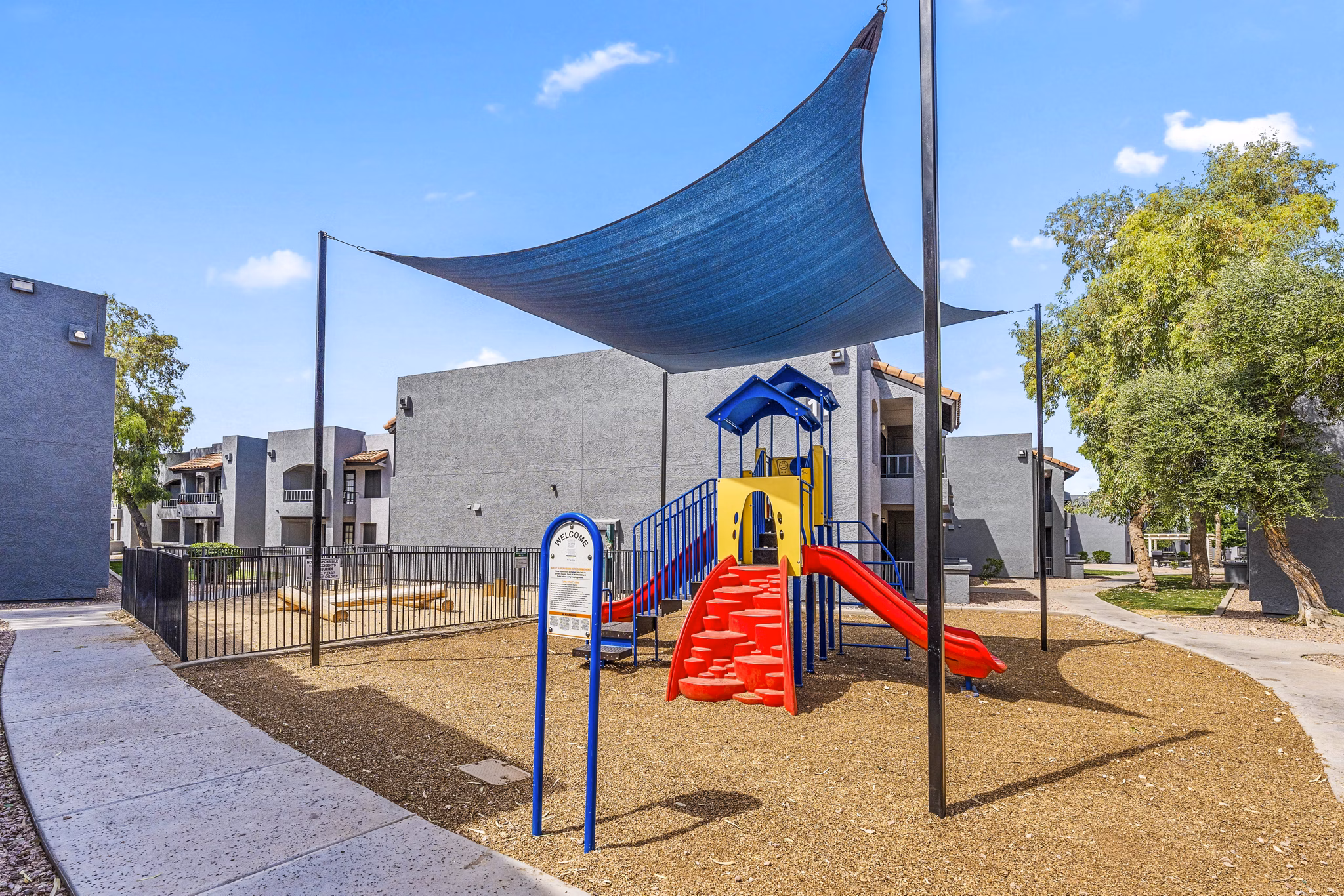 Modern playground with slides and climbing structures at Verve Apartments, offering fun and safe recreational spaces for families and children