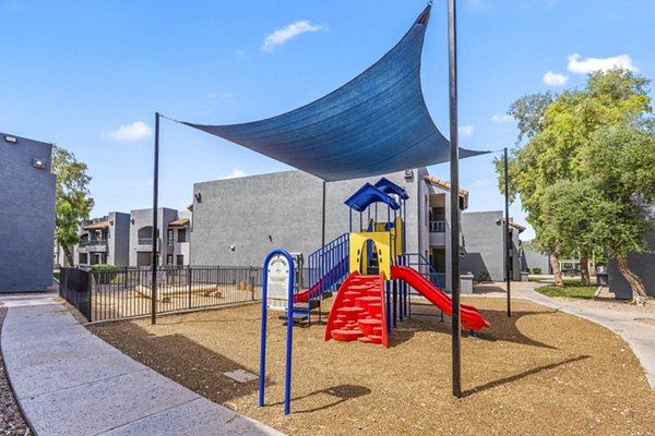 Modern playground with slides and climbing structures at Verve Apartments, offering fun and safe recreational spaces for families and children