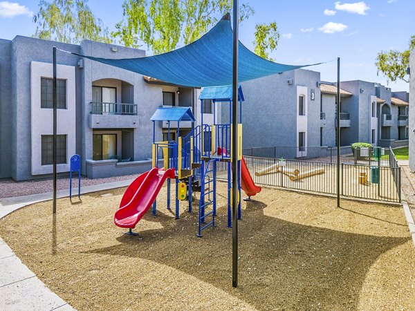 Modern playground with colorful equipment at Verve Apartments for family-friendly outdoor activities
