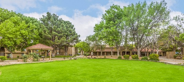 Courtyard featuring lush gardens and seating areas at Cinnamon Tree Apartments