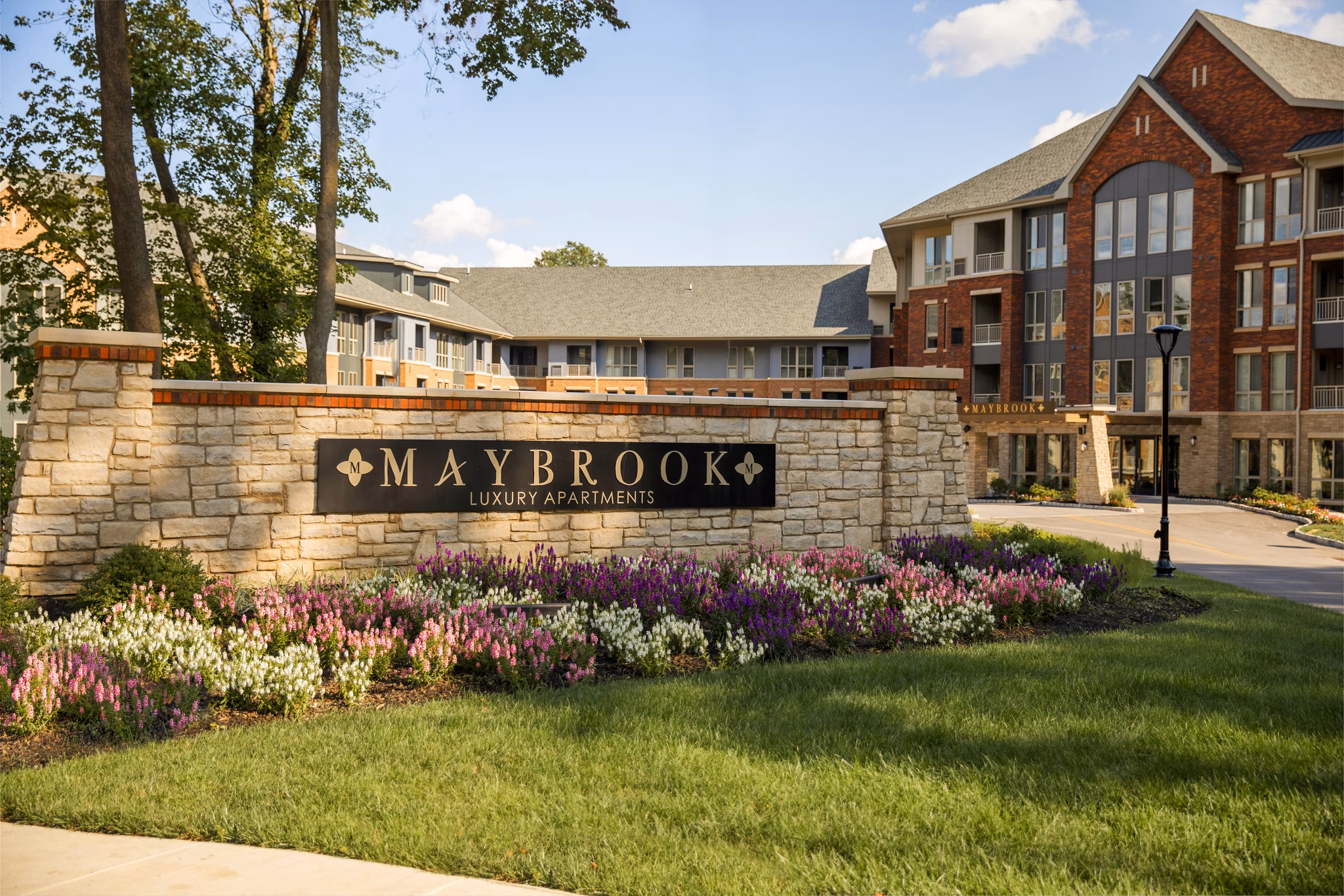 Maybrook Luxury Apartments: Elegant apartment complex with landscaped gardens in front