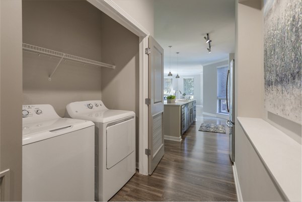 Laundry room equipped with modern appliances at Maybrook Apartments, providing convenience and efficiency for residents