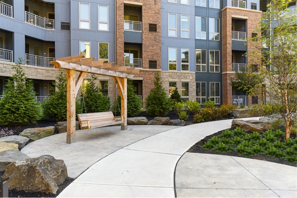 Modern courtyard with lush landscaping at Maybrook Apartments, a Greystar community