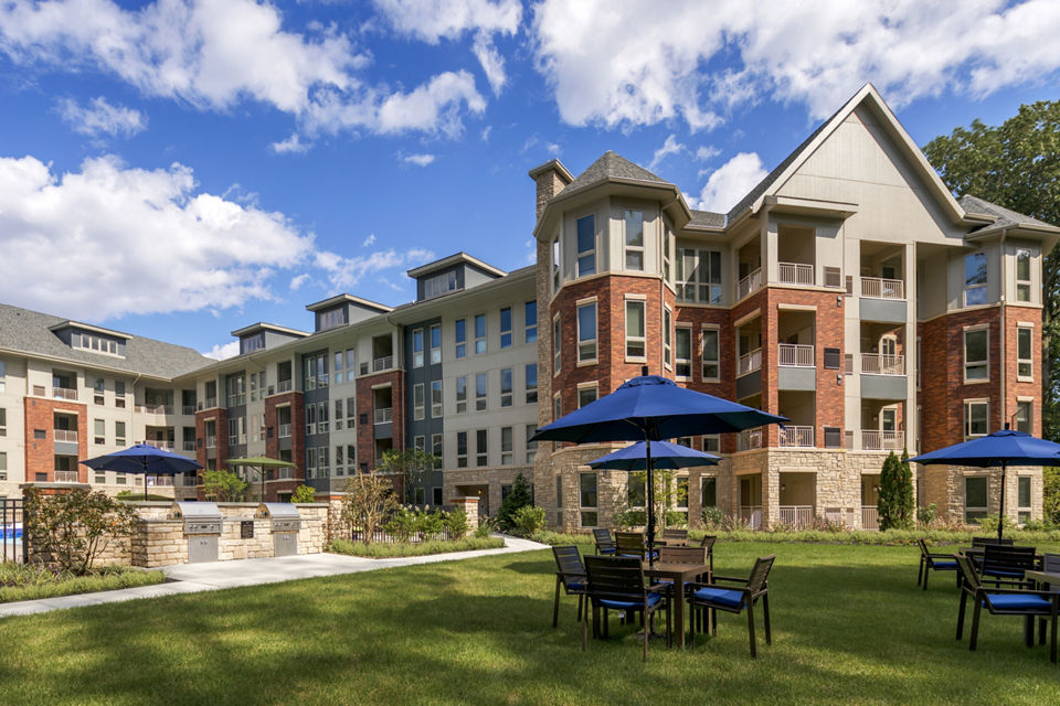 Outdoor grill area with modern seating at Maybrook Apartments offering luxury living experiences