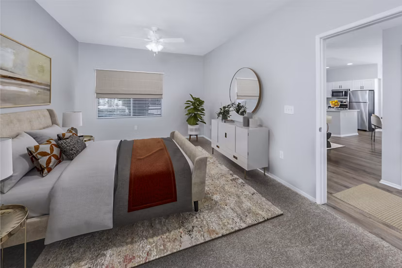 The Village on 5th Apartments: Cozy bedroom with stylish decor and ample natural light in luxury setting