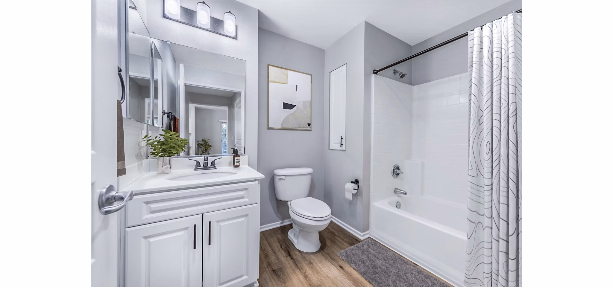 The Village on 5th Apartments: Modern bathroom with sleek fixtures and marble countertop