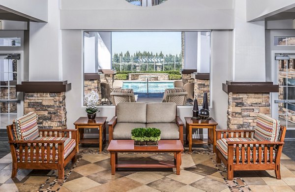 Patio with comfortable seating and lush greenery at The Village on 5th Apartments in Anaheim, offering a relaxing outdoor space for residents