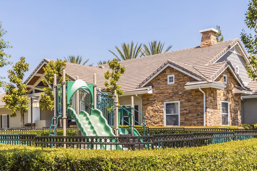 Playground with swings and slides at The Village on 5th Apartments, a Greystar luxury community