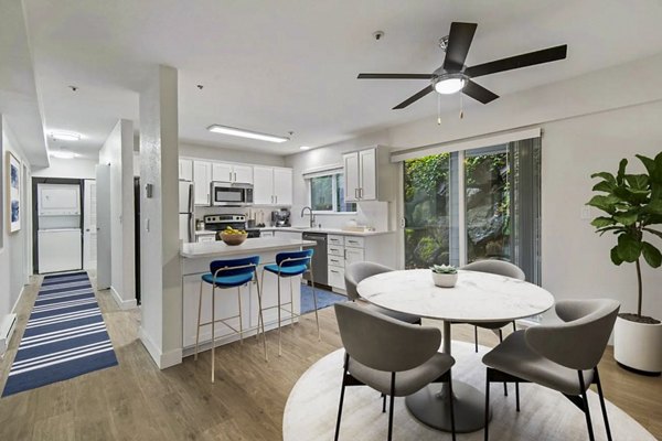 Dining room with elegant chandelier and hardwood floors at Lakeview at Newcastle Apartments