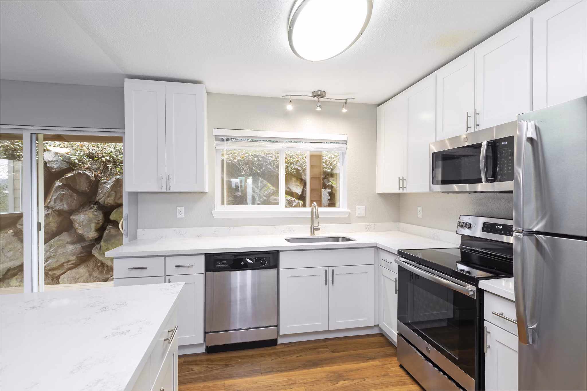 Modern kitchen with stainless steel appliances in Cedar Rim Apartments