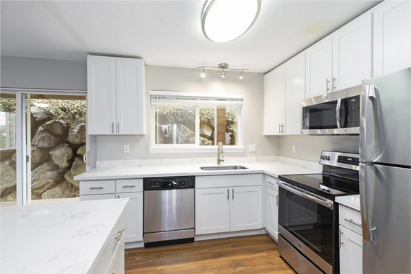 Modern kitchen with stainless steel appliances in Cedar Rim Apartments